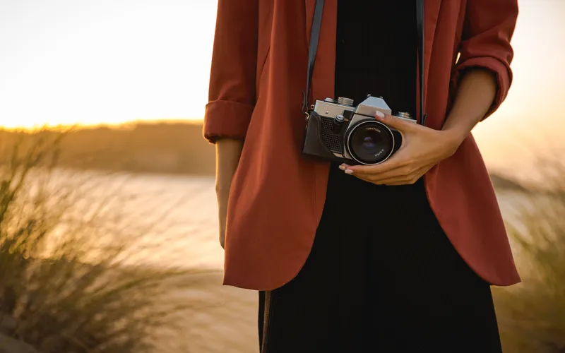 image of a woman holding a vintage camera