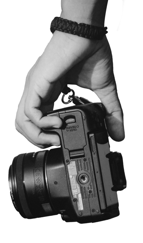 black and white image of a hand holding a camera
