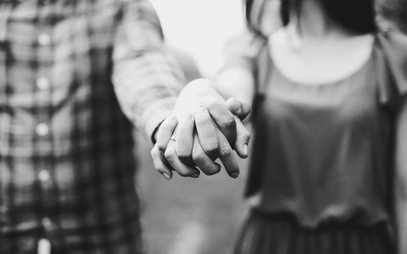 holding hands black and white photo