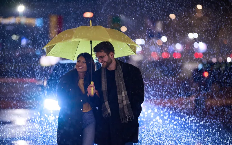 couple sharing an umbrella while it rains
