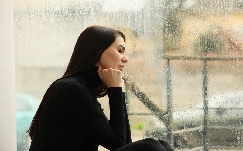 indoor cozy photoshoot by the window in the rain
