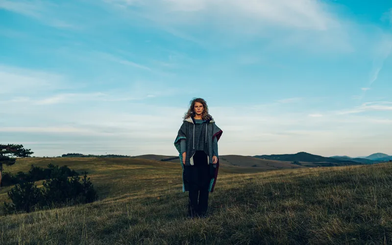 portrait of a woman traveller on a mountain peak