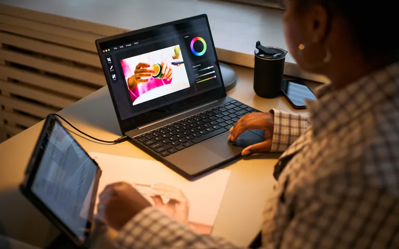 woman working on a computer with photo editing software