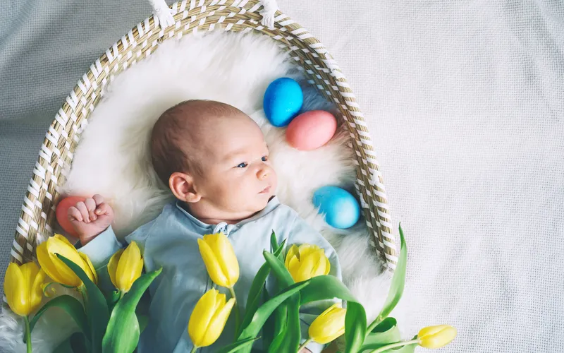 easter photoshoot of baby in a basket