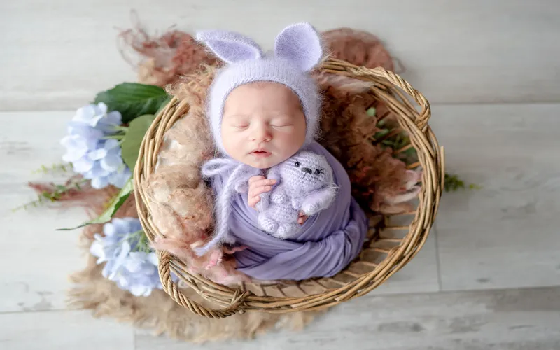 baby sleeping in a nest for easter themed photoshoot