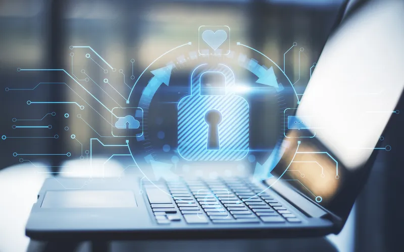 photo of laptop with abstract glow and hologram of lock