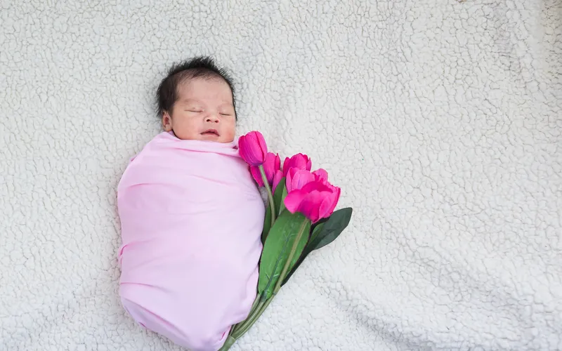 easter photoshoot of a baby with spring flowers