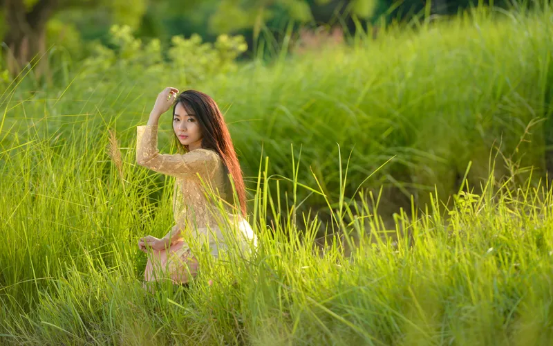 woman portrait taken outdoors in grassy field