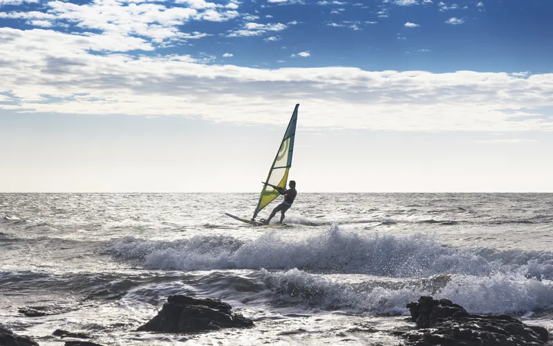 Wind surfer captured mid-jump against the sky at 1/2000 sec shutter speed