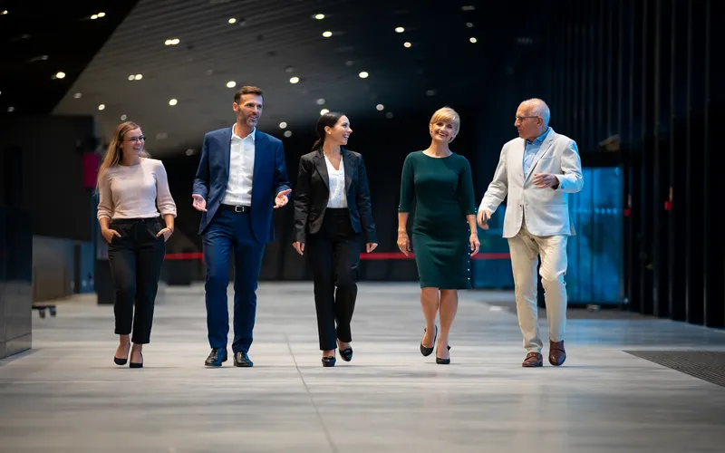 photo of professionals taken in office while they are strolling through their office