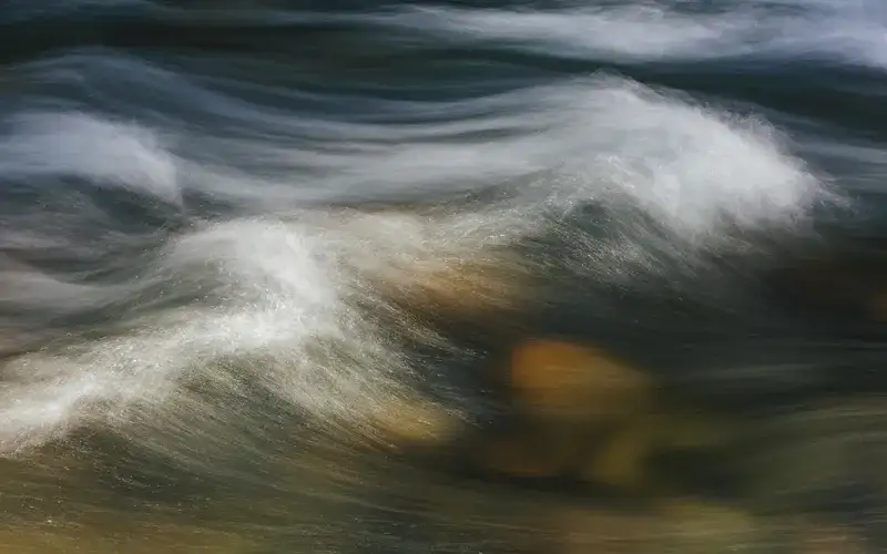 over and long exposure of abstract of flowing river water