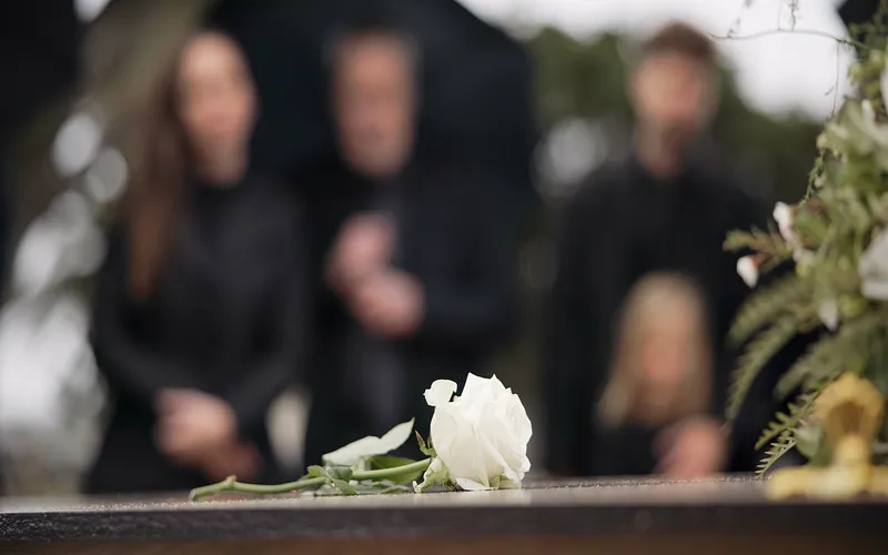mourners and a white rose