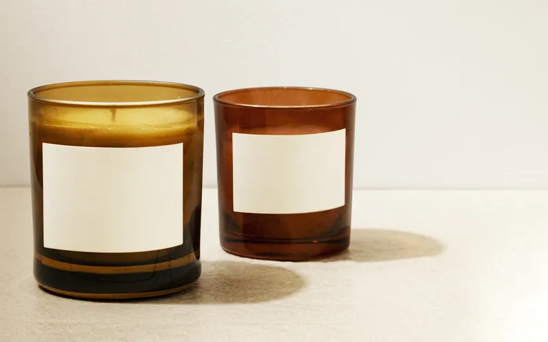 two candles with white blank labels on them
