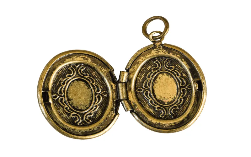 a golden necklace that opens up and can keep a picture in it