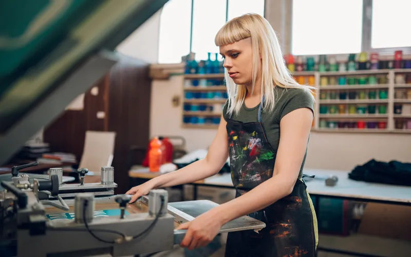 a print shop worker printing on tshirts