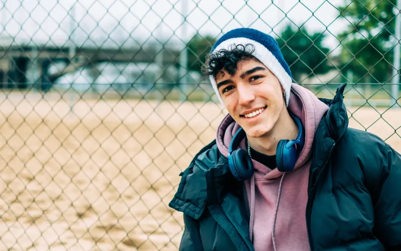 senior portrait ideas near chain-link fences