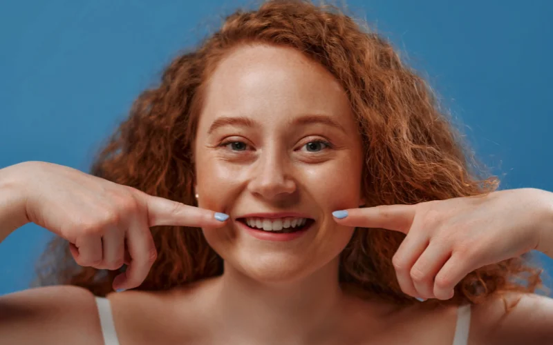 smile while showing your teeth