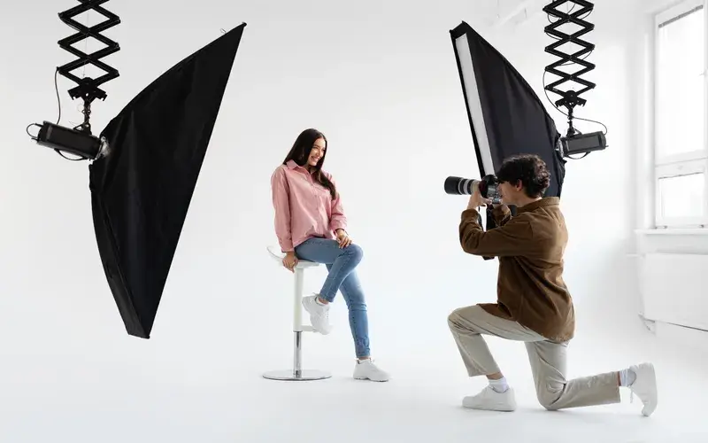 woman getting her photoshoot done in a studio with professional photographer