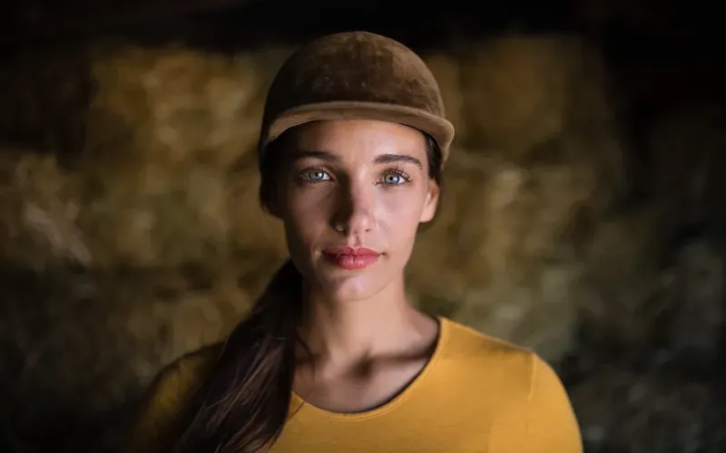 A women wearing a cap and posing for a photo