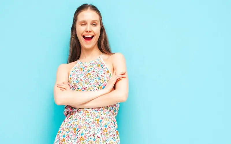 Woman with a soft, relaxed smile against a plain background, showing how to be more photogenic female portraits