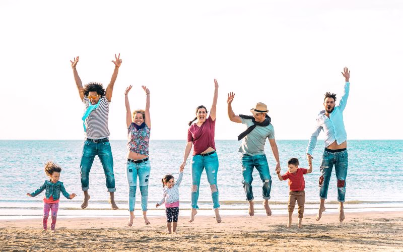 Family jumping together on the beach