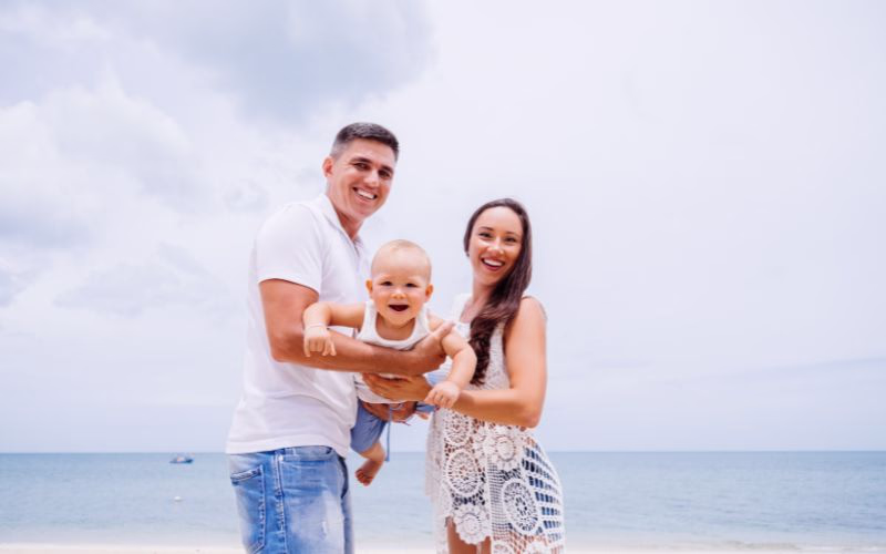 A couple holding their kid in between them