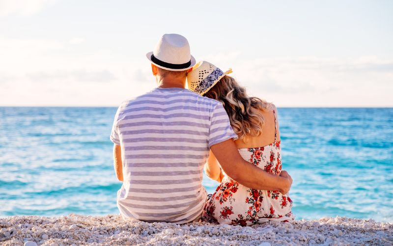 beach photography of couple resting head on the partner's shoulder