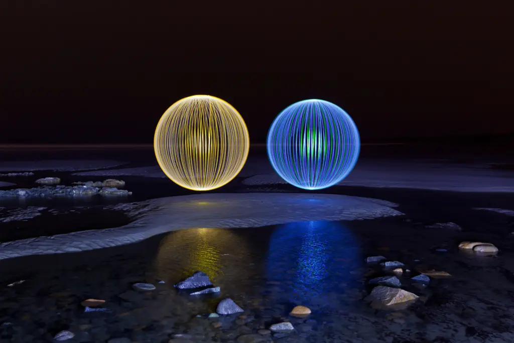 Two colorful light painting orbs created with long exposure techniques