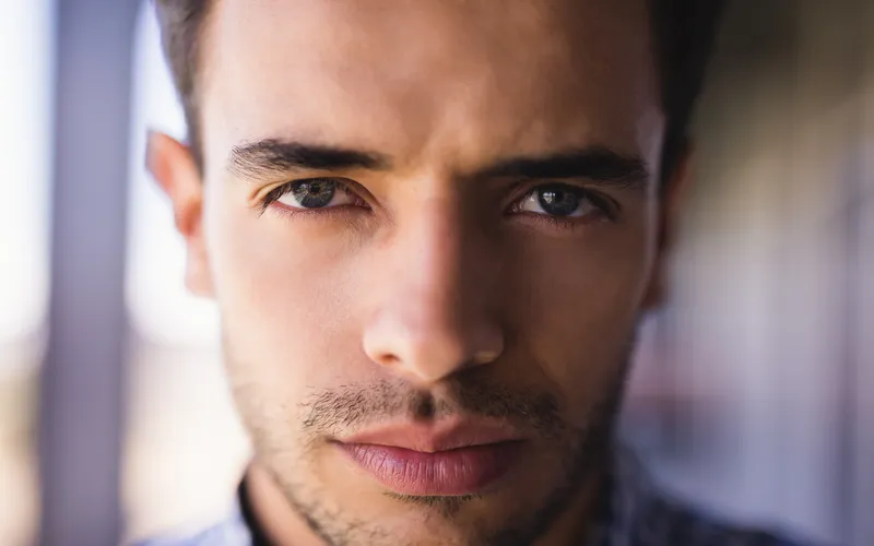 closeup portrait of man with black-brown eyes