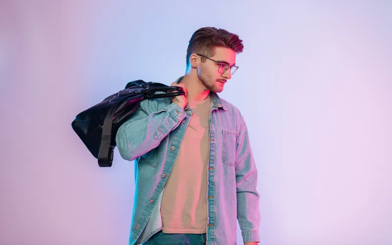 man posing with jacket over his shoulders