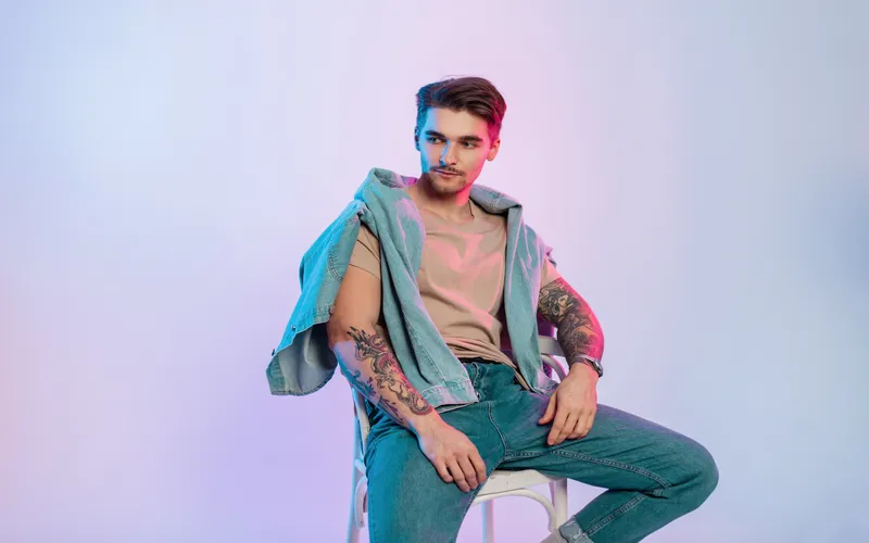 man posing for a photo while sitting on a chair