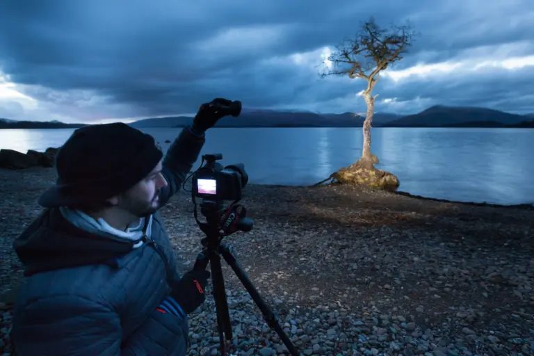 Photographer demonstrating a light painting photography setup