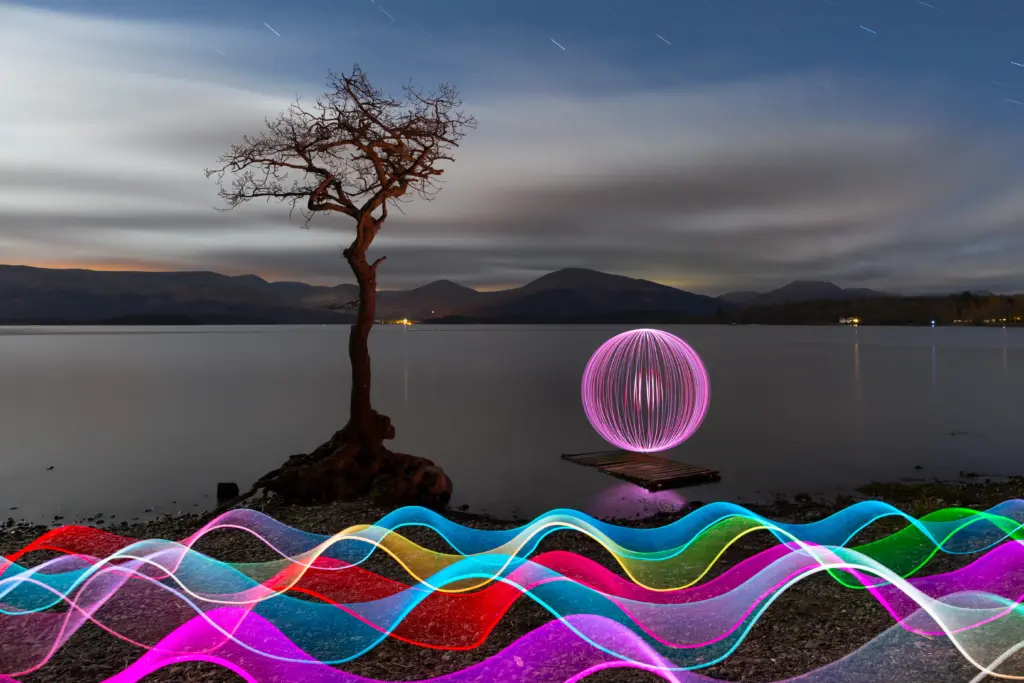 Creative light painting landscape featuring colorful light trails and orb