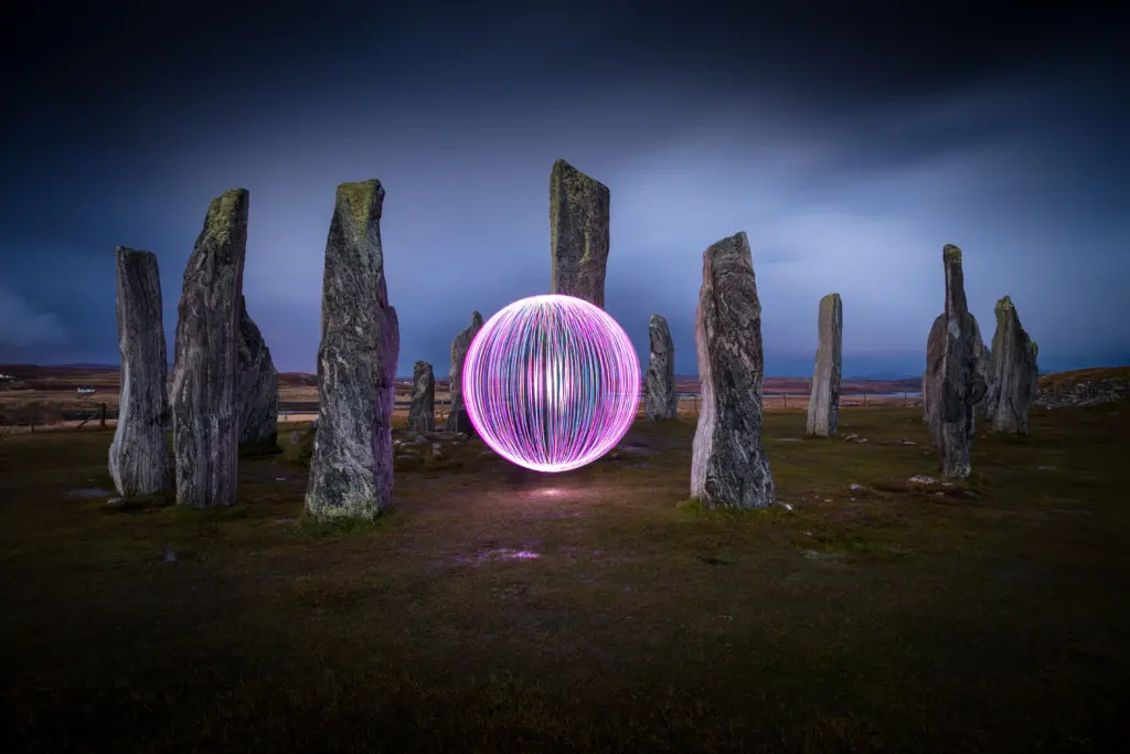 Creative light painting orb photographed at a stone circle during blue hour
