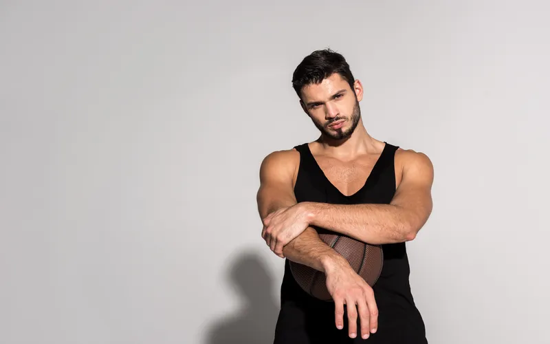man posing with basketball