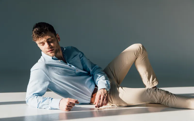 man posing for photoshoot while lying on his side on the floor