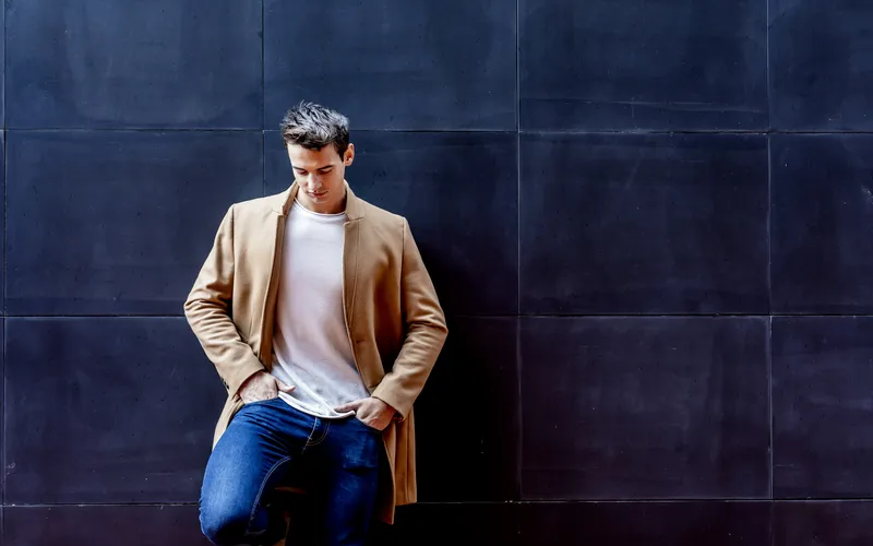 young man posing with hands in his pockets